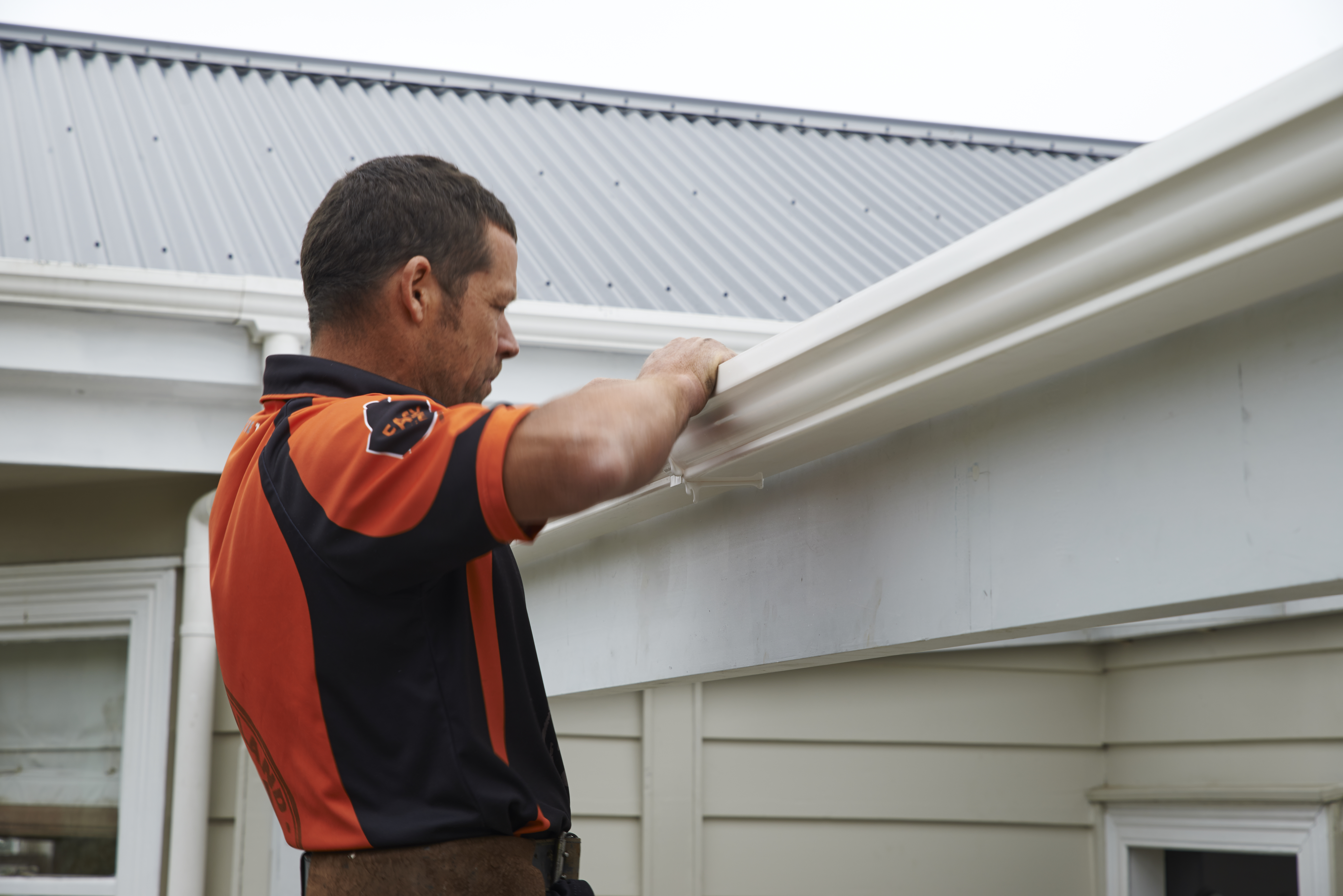 Stan cleaning a gutter